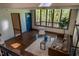 Bright living room featuring hardwood floors, a comfortable sofa, and a large window with wooded views at 3719 W Cornwallis Rd, Durham, NC 27705