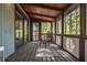 Relaxing screened porch with wood ceiling, flooring, and wooded views, providing a serene outdoor retreat at 3719 W Cornwallis Rd, Durham, NC 27705