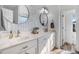 Bright bathroom with double sink vanity, patterned accent wall, modern fixtures and decor at 387 Windgate Dr, Clayton, NC 27527