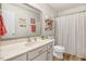 Bathroom featuring a single vanity, decorative shelves and a shower with a curtain at 387 Windgate Dr, Clayton, NC 27527