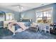 Bedroom featuring blue walls and carpet, vanity, accent chair, and lots of natural light at 387 Windgate Dr, Clayton, NC 27527
