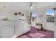 Bright bedroom featuring built in storage, purple carpet, and abundant natural light from multiple windows at 387 Windgate Dr, Clayton, NC 27527