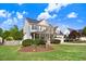 Two-story house featuring a covered porch, well-kept lawn, and classic architectural details for curb appeal at 387 Windgate Dr, Clayton, NC 27527