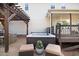 Exterior shot featuring hot tub, pergola, and outdoor kitchen on a stone patio at 387 Windgate Dr, Clayton, NC 27527