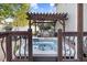 Relaxing hot tub beneath pergola next to an outdoor kitchen and a wooden privacy fence at 387 Windgate Dr, Clayton, NC 27527