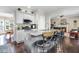 Beautiful kitchen features an island with bar seating, stainless appliances, and seamless flow to the living room at 387 Windgate Dr, Clayton, NC 27527