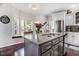 Kitchen island with granite countertops, stainless steel sink, and barstool seating creates a warm and inviting space at 387 Windgate Dr, Clayton, NC 27527
