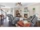 Cozy living room features a fireplace, a ceiling fan, hardwood floors, and comfortable furniture at 387 Windgate Dr, Clayton, NC 27527