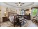 Comfortable main bedroom featuring tray ceilings, ceiling fan, decor, and natural light from two windows at 387 Windgate Dr, Clayton, NC 27527