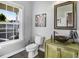 Charming powder room with a unique vessel sink, decorative mirror, and natural light at 387 Windgate Dr, Clayton, NC 27527