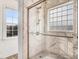 Beautiful tiled shower with glass doors and window, complemented by natural light and modern fixtures at 387 Windgate Dr, Clayton, NC 27527