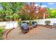 Inviting backyard brick patio with comfortable seating and beautiful mature trees at 3920 Bentley Brook Dr, Raleigh, NC 27612