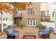 Beautiful backyard patio featuring a mix of seating arrangements, brickwork, and manicured landscaping at 3920 Bentley Brook Dr, Raleigh, NC 27612