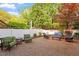 Secluded brick patio with comfortable seating, surrounded by vibrant greenery and privacy fence at 3920 Bentley Brook Dr, Raleigh, NC 27612