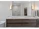 Bathroom with double sink vanity and modern fixtures, with tiled shower reflected in large mirror at 3920 Bentley Brook Dr, Raleigh, NC 27612