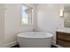 Bathroom showcasing a free-standing soaking tub, natural light, and modern vanity at 3920 Bentley Brook Dr, Raleigh, NC 27612