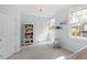 Bright bedroom featuring a modern chandelier, ample natural light, and a charming bookcase with toys at 3920 Bentley Brook Dr, Raleigh, NC 27612