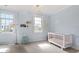 Cozy Bedroom with natural light, featuring a white crib and light blue walls at 3920 Bentley Brook Dr, Raleigh, NC 27612