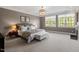 Bright bedroom with carpeted floors, neutral walls, large windows, and a comfortable bed at 3920 Bentley Brook Dr, Raleigh, NC 27612