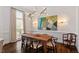 Bright dining room with hardwood floors, modern lighting, and elegant wall art at 3920 Bentley Brook Dr, Raleigh, NC 27612