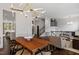Open-concept dining room with modern lighting and view of a staircase and kitchen at 3920 Bentley Brook Dr, Raleigh, NC 27612