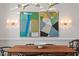 Dining room with modern lighting, a wooden table, and elegant artwork enhancing the ambiance at 3920 Bentley Brook Dr, Raleigh, NC 27612