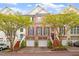 Charming brick townhome with two-car garage, mature trees, and manicured landscaping at 3920 Bentley Brook Dr, Raleigh, NC 27612