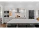 Modern kitchen featuring a large island, stainless steel appliances, and sleek white cabinetry at 3920 Bentley Brook Dr, Raleigh, NC 27612