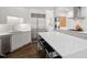 Modern kitchen with white cabinets, stainless steel appliances, and a large center island with bar stool seating at 3920 Bentley Brook Dr, Raleigh, NC 27612