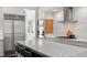 Bright kitchen with stainless appliances, island with seating, and marble backsplash at 3920 Bentley Brook Dr, Raleigh, NC 27612