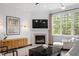 Cozy living room with a fireplace, large windows, and plenty of natural light at 3920 Bentley Brook Dr, Raleigh, NC 27612