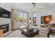Bright living room boasts fireplace, large windows, neutral tones, and lots of comfortable seating at 3920 Bentley Brook Dr, Raleigh, NC 27612