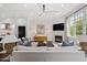 Spacious living room with fireplace, modern lighting, and plenty of natural light at 3920 Bentley Brook Dr, Raleigh, NC 27612