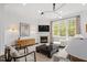 Living room with a fireplace, modern decor, and ample seating at 3920 Bentley Brook Dr, Raleigh, NC 27612