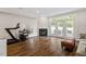 Finished basement with a fireplace, exercise equipment, and access to the outside at 3920 Bentley Brook Dr, Raleigh, NC 27612