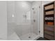 Walk-in shower featuring glass enclosure, white tiled walls, bench, and modern fixtures at 3920 Bentley Brook Dr, Raleigh, NC 27612