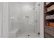Shower featuring glass door, tiled walls and floors, bench, and modern fixtures at 3920 Bentley Brook Dr, Raleigh, NC 27612