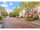 Charming street view featuring townhomes with brick accents and well-maintained landscaping at 3920 Bentley Brook Dr, Raleigh, NC 27612