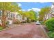 Inviting street featuring townhomes with beautiful brick exteriors, and well-manicured greenery at 3920 Bentley Brook Dr, Raleigh, NC 27612