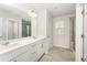 Bright bathroom featuring double vanity, a large mirror, and a glass door shower at 4005 Sierra Pelona Dr, Raleigh, NC 27616