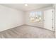 Bright and spacious bedroom with soft carpet and natural light from a window overlooking a neighborhood at 4005 Sierra Pelona Dr, Raleigh, NC 27616
