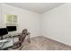 Cozy room with gray walls, carpeted flooring, and a window, featuring a computer desk and chair at 4005 Sierra Pelona Dr, Raleigh, NC 27616