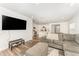 Open-concept living room featuring a comfortable gray sectional and seamless flow to the kitchen at 4005 Sierra Pelona Dr, Raleigh, NC 27616