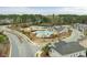 An aerial view of the community pool, tennis court, playground, and residential homes nestled among mature trees at 416 Glenview Ln, Durham, NC 27703