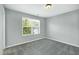 Carpeted bedroom with a window offering natural light and views of the outdoors at 416 Glenview Ln, Durham, NC 27703