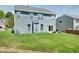 Two-story home with blue siding, a spacious backyard with green grass, and a patio area at 416 Glenview Ln, Durham, NC 27703