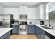 Modern kitchen featuring two-tone cabinetry, stainless steel appliances, and white marble countertops at 416 Glenview Ln, Durham, NC 27703