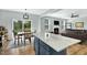 Open-concept kitchen with an island, granite countertops, dining table, and view of the living room and backyard at 416 Glenview Ln, Durham, NC 27703