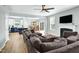 Open-concept living space with a cozy fireplace, hardwood floors, and access to the kitchen and dining area at 416 Glenview Ln, Durham, NC 27703