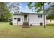 Exterior view of the back of the house showcasing a backyard and access steps at 431 Waddill St, Henderson, NC 27536